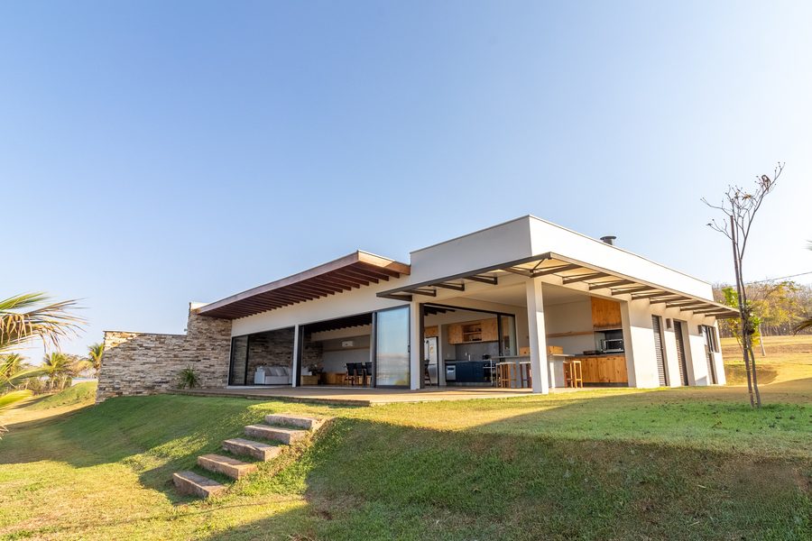 Fachada de uma casa com a escada para o gramado